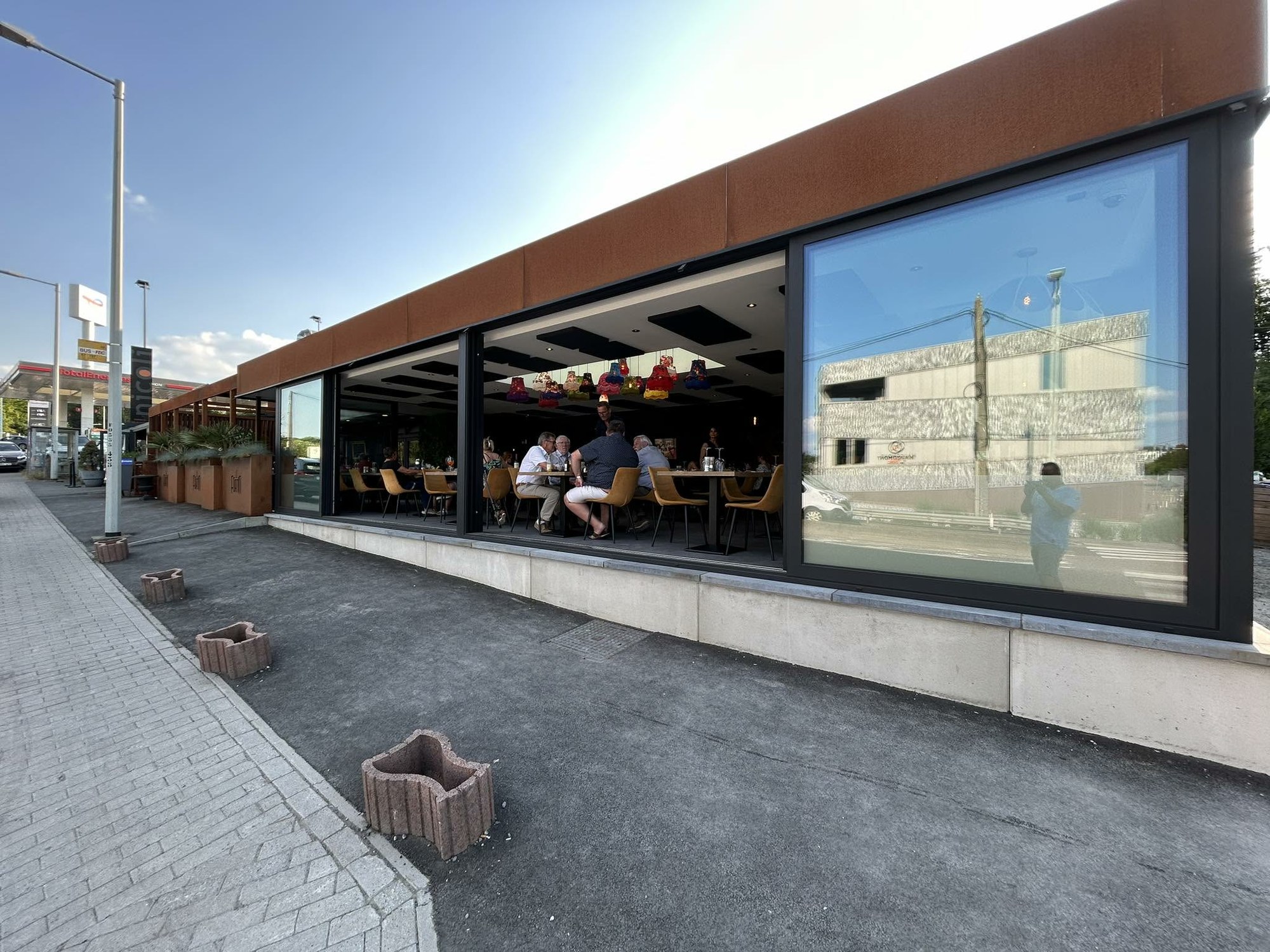 Longue façade commerciale vitrée en aluminium foncé